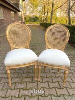 Exquisite Pair of French Louis XVI Cane Back Dining Chairs with Gold Leaf Finish