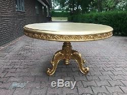 French Louis XVI style round dining table in gold. Worldwide shipping