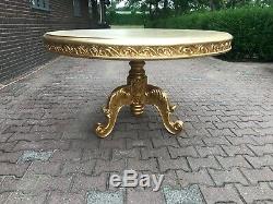 French Louis XVI style round dining table in gold. Worldwide shipping