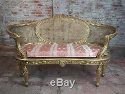 Louis XVI Vintage Cane Back Gilt Settee withPink Striped Cushion