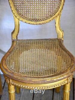 Pair of 18th Century Louis XVI gilded cane chairs